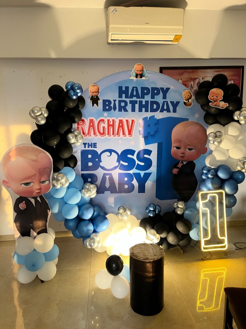 Boss Baby themed first birthday with blue, black and silver balloons and a neon number one