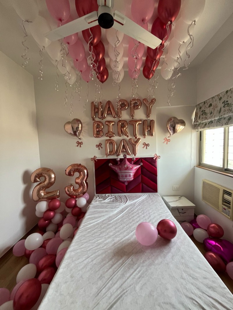 Surprise room with pink, white and berry ceiling balloons, rose-gold foil letters, number balloons and a crown foil