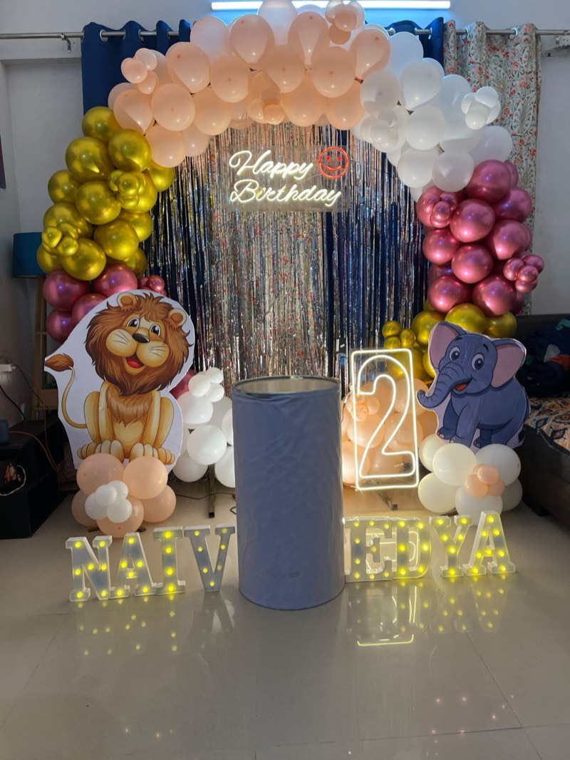 Safari themed arch with lion and elephant cut-outs, neon number two and light-up name letters