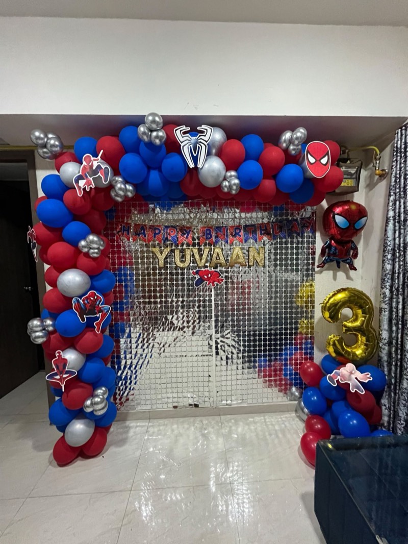 Spider-Man themed red, blue and silver balloon garland with a shimmer wall and gold number three