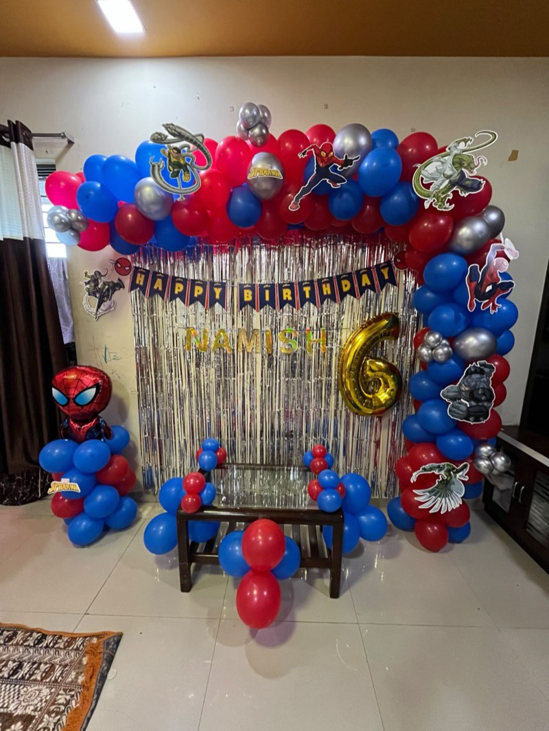 Red, blue and silver balloon arch with Spider-Man characters, a gold number six and a foil Spider-Man balloon